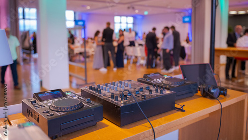 DJ equipment in event location with blurred people in background