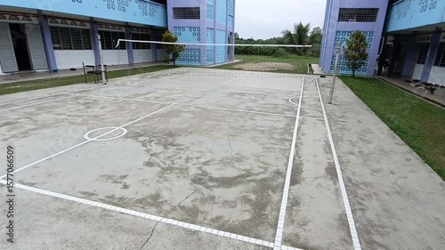 Wallpaper Mural sepaktakraw or takraw ball  or buka ball, kick volleyball or foot volleyball old  court with net and white lines on a sunny day. photo taken in malaysia Torontodigital.ca