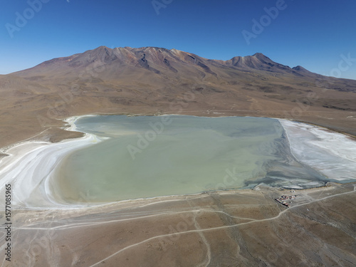 Aerial view of the shimmering Laguna Celeste mirroring the stark desert landscape under a clear sky, San Pablo de LÃ­pez, Potosi Department, Bolivia.