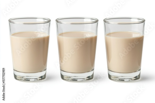 Three glasses of bailey's irish cream liqueur on white background cocktail shots creamy drink alcohol