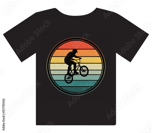 Dynamic BMX rider performing stunts against a vibrant retro sunset graphic on a black t-shirt.