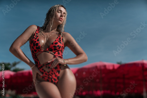 Photos Beautiful and sexy girl posing in threesome against the background of water in a