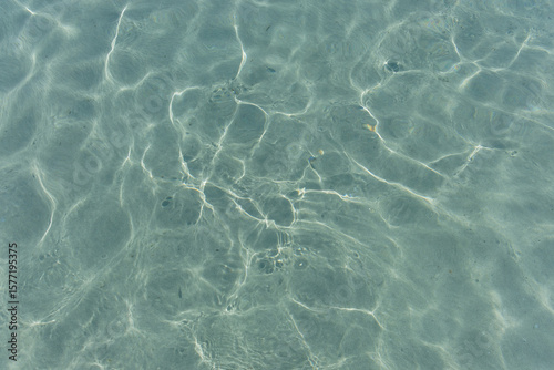 Fototapeta Naklejka Na Ścianę i Meble -  Texture of the sea water surface with small waves and sun reflections.