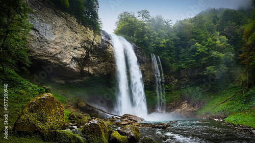 Breathtaking Waterfall Deep in Icelandic Valley with Dramatic Clouds and Lush Green Hills, Ideal for Nature Wallpapers, Eco Travel Destinations, and Wilderness Exploration