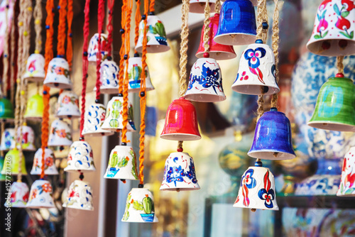 Tableau sur toile Colorful traditional Iznik ceramic bells as souvenirs displayed in market shop i