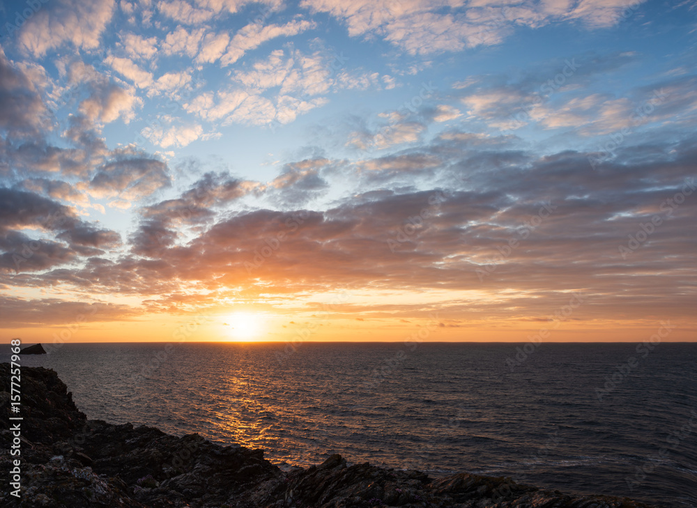 Fototapeta premium Beautiful vibrant Summer sunset landscape image of Pentire Headland in Cornwall England with dramatic sky