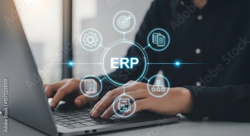 Wallpaper Mural Executive using laptop for ERP system, enterprise resource planning, showing efficiency and data flow with modern technology integrations Torontodigital.ca