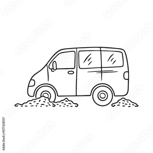 A van tire partially sunken into a loose gravel driveway