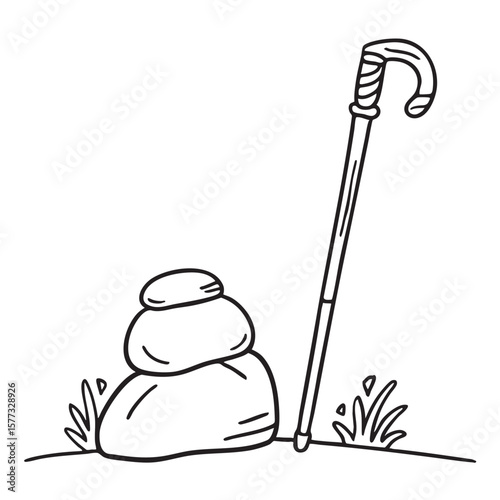 A wooden staff resting on a boulder by the edge of a valley