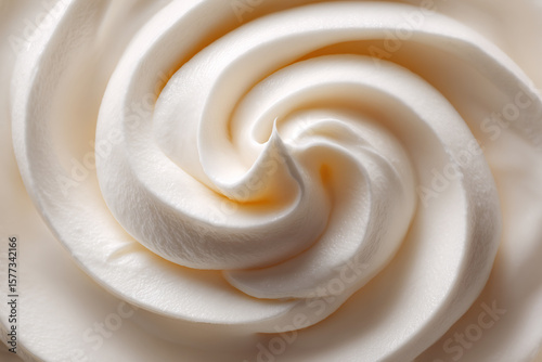 Delicate swirls of soft white frosting, a sweet and creamy confection. A perfect topping or dessert element, artistically swirled.