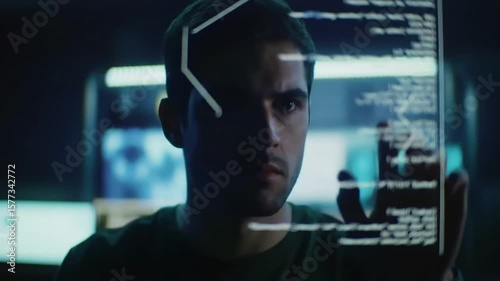 Focused programmer interacts with a transparent holographic display showing lines of code.