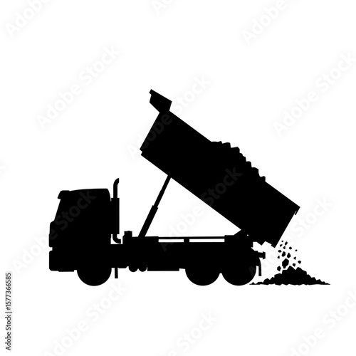 Silhouette of a heavy-duty dump truck actively unloading a load of gravel or dirt from its raised bed onto the ground.