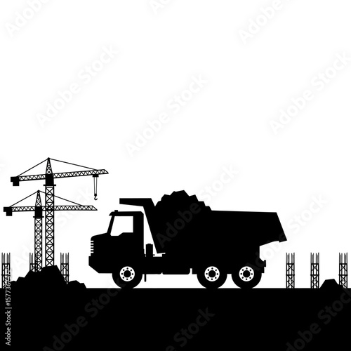 Silhouette of a dump truck at a construction site with cranes and barriers, conveying the hard work and progress of a building project.
