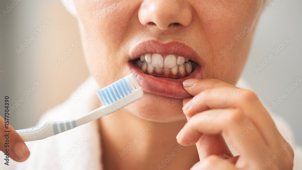 Fototapeta premium Young woman looking at her red bleeding gums