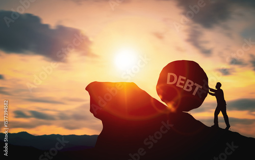 Silhouette of a businessman pushing a stone with word Debt up a mountain. Concept of debt burden and debt management, financial challenges and effective money management.