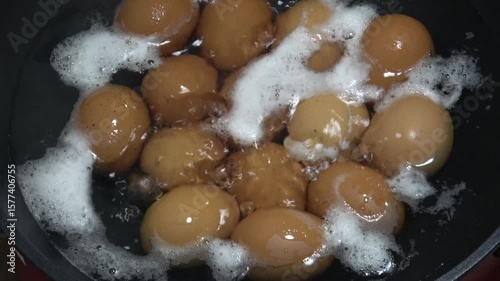 Hard boiling eggs in hot pot. Bubbling hot water.