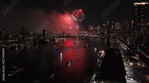 Macy's 4th of July fireworks celebration over East River New York, night aerial