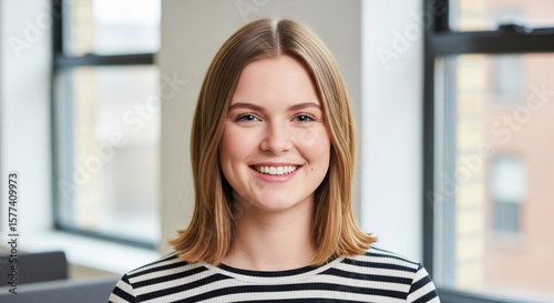 Free Download A smiling young caucasian woman with blonde hair, looking confidently at the camera - GFXLoad