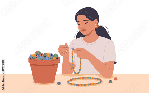 flat vector of Young woman creating colourful beaded jewellery while sitting at a table with a pot of beads