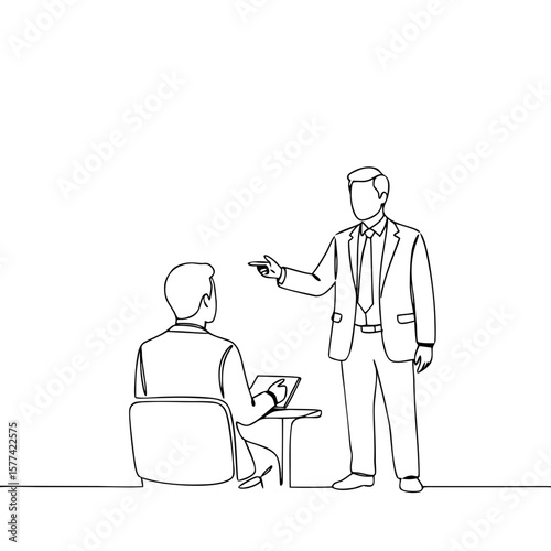 Businessman giving instructions to employee in office setting  