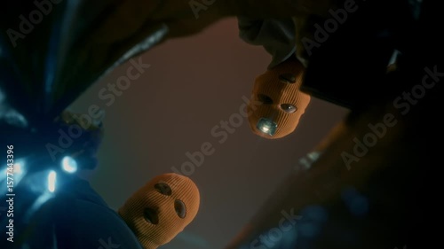 Repeated robbers wearing masks and headlamps put their loot in a large black bag. Camera view from inside the bag