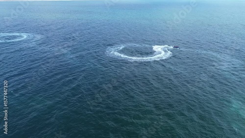 Aerial view of surfing boat with tourists having fun from the top , video made by drone