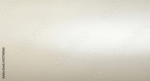 Subtle shimmer and shine illuminates a smooth, neutral beige surface, ideal for backgrounds, textures, and elegant design projects.