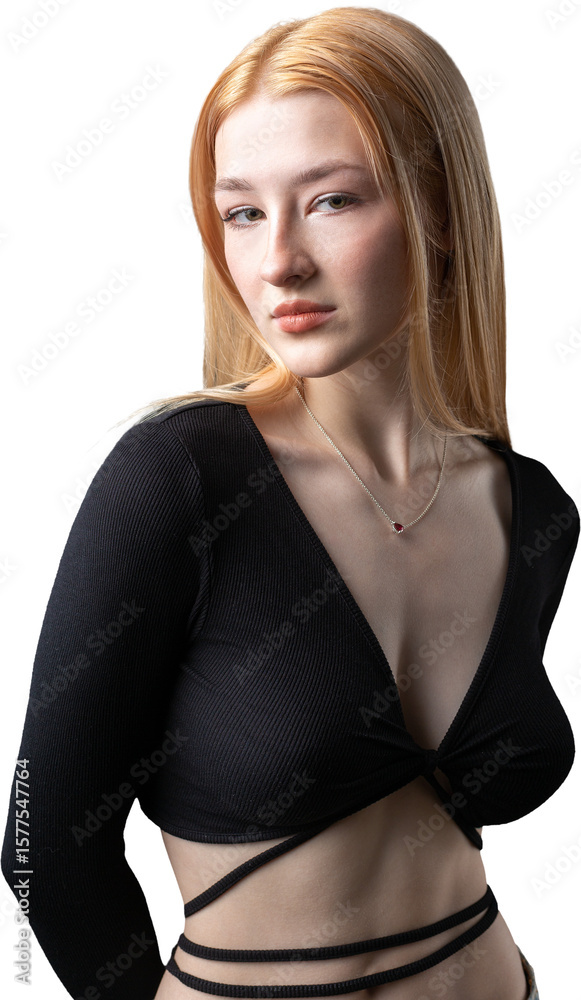 Fototapeta premium Portrait of a blonde woman with freckles in a sexy top and denim shorts in a studio.
