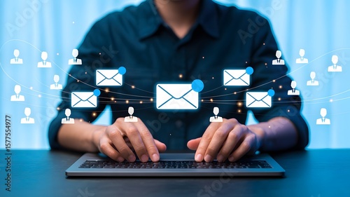 Business professional working on a laptop sending emails, connecting with clients through email marketing and social media networks.