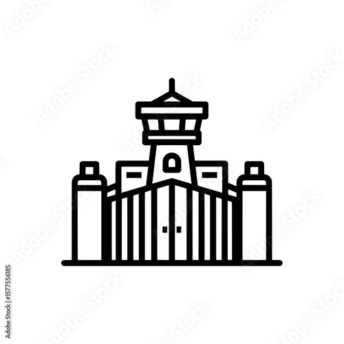 prison tower with gate and fences at night