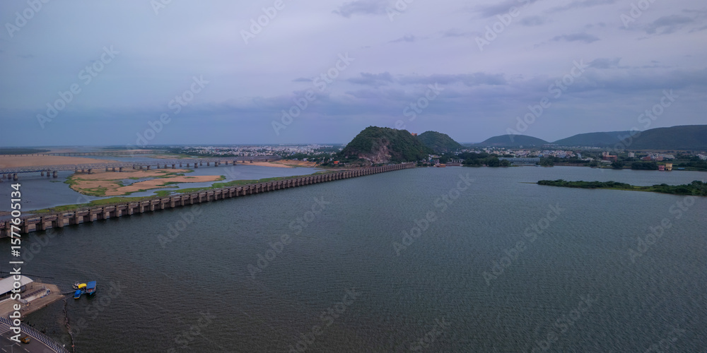 Fototapeta premium Aerial panoramic view of historic Prakasam barrage on the Krishna river during evening time at Vijayawada, India