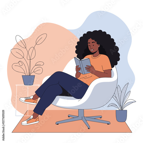 Young Black woman reading a book while relaxing in a modern chair  