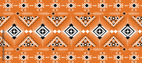 A vibrant, geometric tribal pattern in orange, black, and white featuring diamond and triangular shapes with intricate symmetric details.