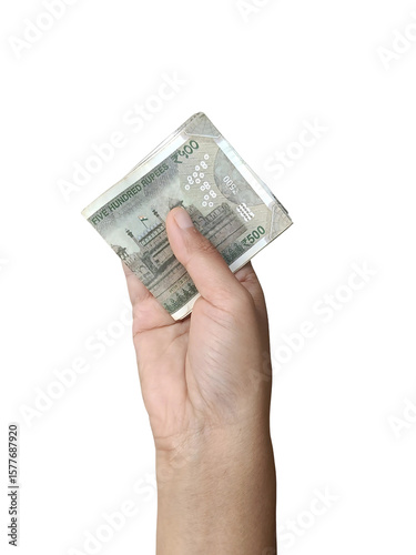 Hand holding a few Indian 500 rupee notes in a folded form, concept of savings, cash, earnings, financial.