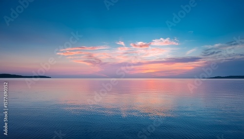 tranquil pastel sunset reflects on calm water
