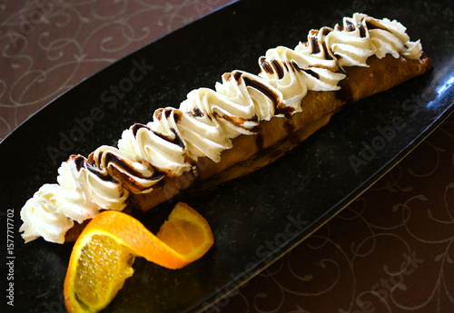 fresh bakede rolled homemade cake on a black plate