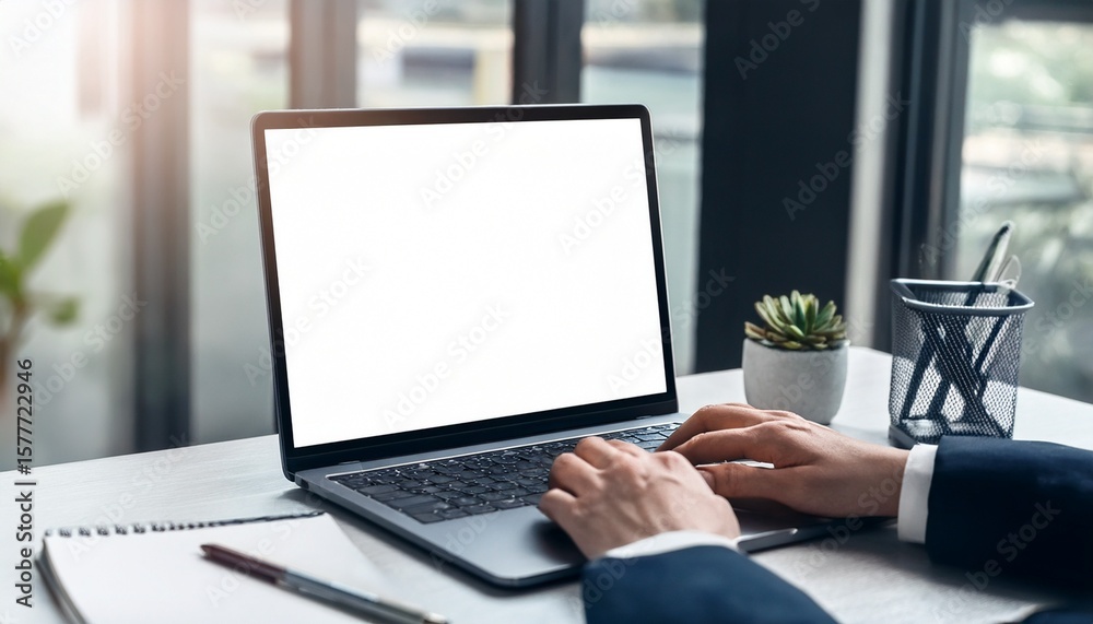 hand typing laptop computer showing blank screen on table office place hand typing laptop computer showing blank screen on table office place