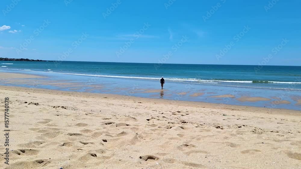 woman walking on Matosinhos beach in Portugal woman walking on Matosinhos beach in Portugal