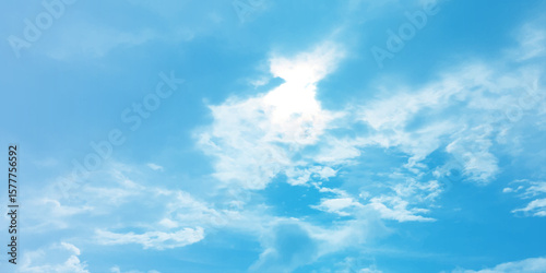 Blue sky, sun, clouds. A peaceful moment with underlying complexity. A reflection of the sky on thin clouds. Hidden emotions beneath a bright exterior like feeling melancholic on a good day background