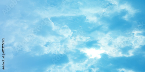 Blue sky, sun, clouds. A peaceful moment with underlying complexity. A reflection of the sky on thin clouds. Hidden emotions beneath a bright exterior like feeling melancholic on a good day background