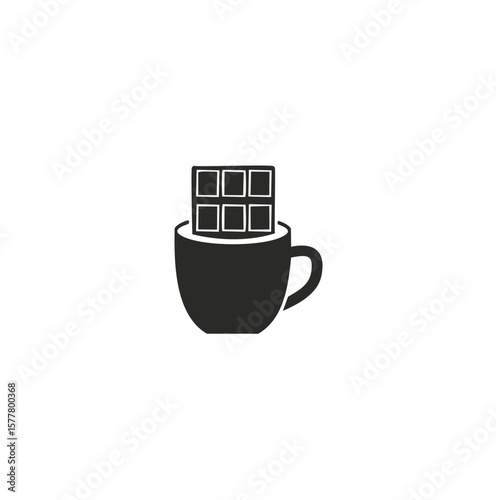Dark chocolate bar resting in a coffee cup drink