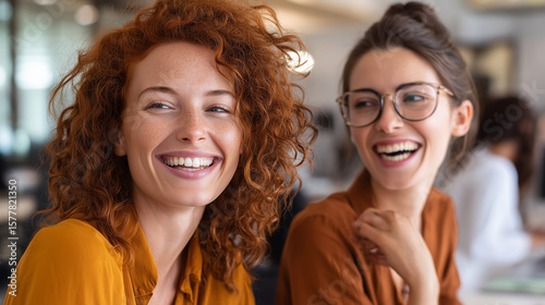 Colleagues sharing a cheerful moment in a professional office workspace
