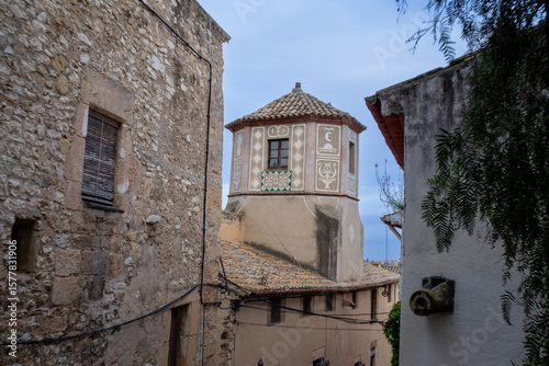 Fototapeta Naklejka Na Ścianę i Meble -  Scenic medieval street in Altafulla, Spain, with colorful facades, stone walls, and vibrant southern charm.