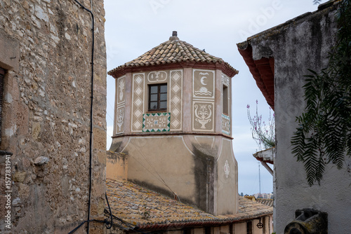 Fototapeta Naklejka Na Ścianę i Meble -  Scenic medieval street in Altafulla, Spain, with colorful facades, stone walls, and vibrant southern charm.