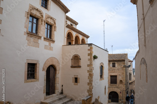 Fototapeta Naklejka Na Ścianę i Meble -  Scenic medieval street in Altafulla, Spain, with colorful facades, stone walls, and vibrant southern charm.