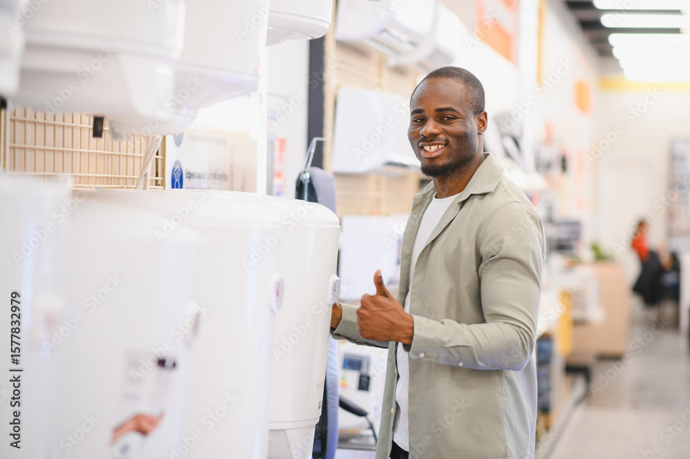 Obraz premium Customer choosing water heater in electronics store appliance section