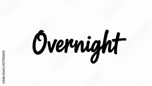 Overnight bold cursive lettering on plain background on a white surface