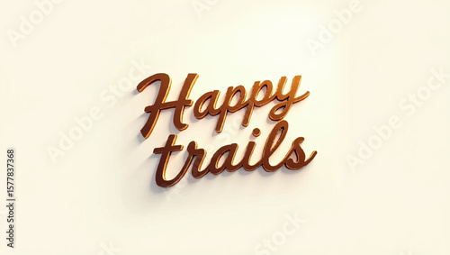 Happy trails is spelled out with metallic lettering on a plain surface