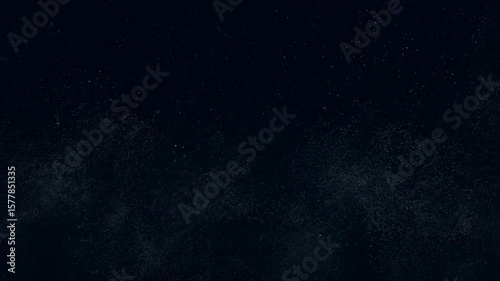 A looping animation of cold, silver micro-particles slowly rising in a zero-gravity environment. The particles drift softly, creating an airy, calm atmosphere over a deep blue-black space.

