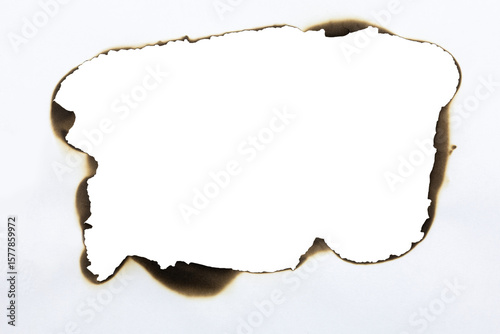 Large burnt hole in white paper creating a grunge frame with scorched edges from fire. Abstract vintage template for text or photos. isolated on white background with clipping path.